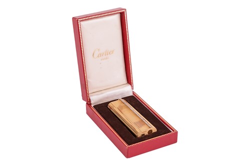 Lot 249 - Cartier - a diamond-set gas lighter of rounded...