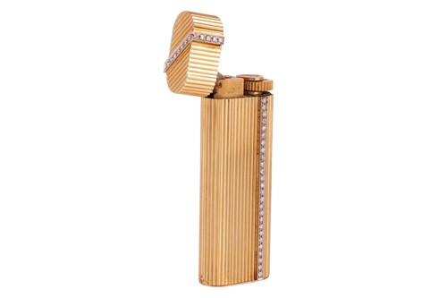 Lot 249 - Cartier - a diamond-set gas lighter of rounded...