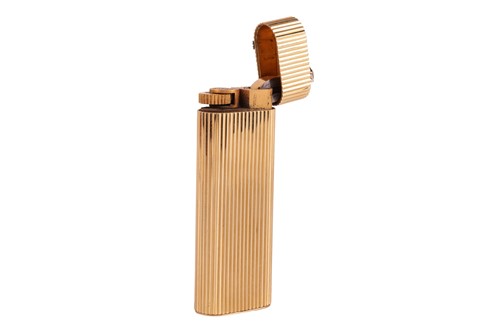 Lot 249 - Cartier - a diamond-set gas lighter of rounded...