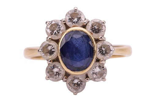 Lot 70 - A sapphire and diamond cluster ring, estimated...