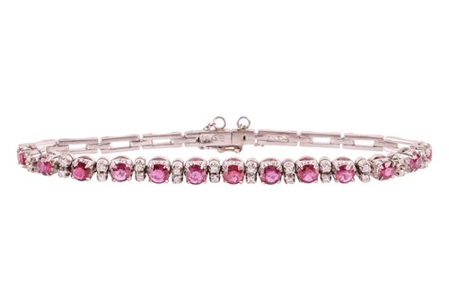 Lot 102 - A ruby and diamond line bracelet, comprising...