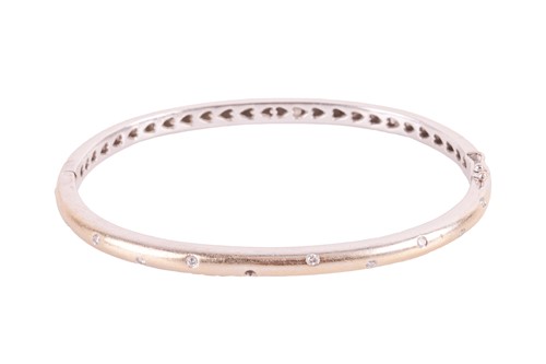 Lot 163 - A diamond-set hinged bangle in 18ct white gold,...