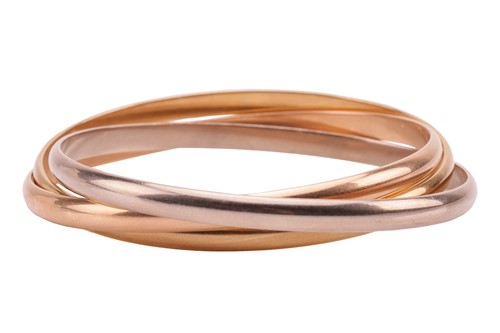 Lot 184 - Cartier – a trinity bangle in 18ct gold,...