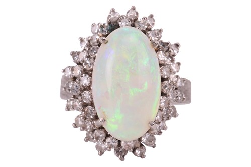 Lot 90 - An opal and diamond cluster ring, centred with...
