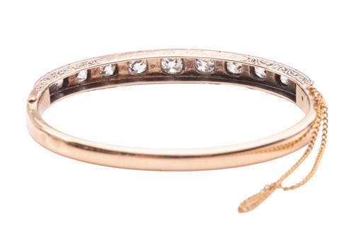 Lot 97 - A Victorian diamond-set hinged bangle, with an...