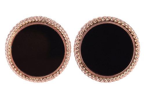 Lot 33 - A pair of onyx-set cufflinks, each containing...