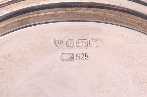 Lot 148 - A cased pair of silver goblets, with a band to...
