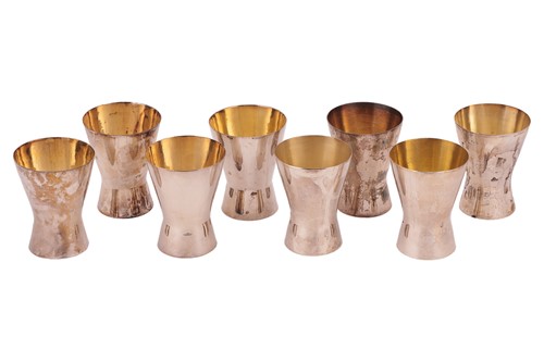 Lot 351 - A set of eight silver beakers of flared form...