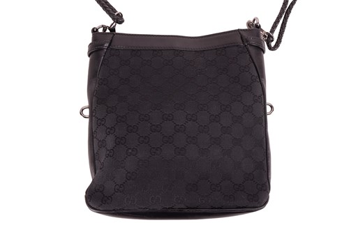 Lot 139 - Gucci - a crossbody bag in black monogrammed...