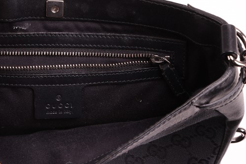 Lot 139 - Gucci - a crossbody bag in black monogrammed...