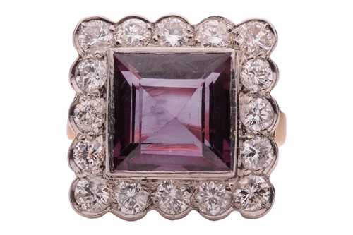 Lot 193 - A gem-set halo ring, collet-set with a square...