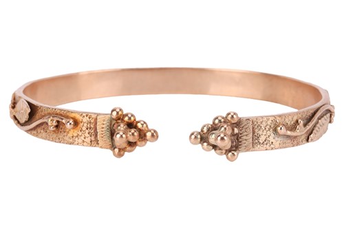 Lot 125 - A bangle of foliate design; an open bangle,...