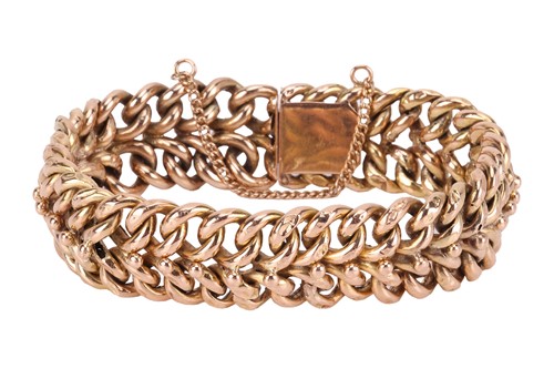 Lot 216 - A double curb chain bracelet, featuring two...