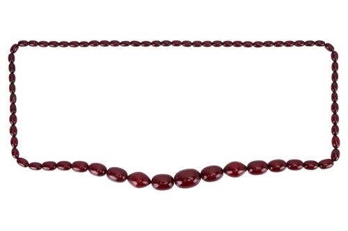 Lot 109 - A single strand red bead necklace, comprising...