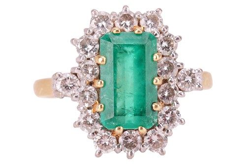 Lot 144 - An emerald and diamond cluster ring, featuring...