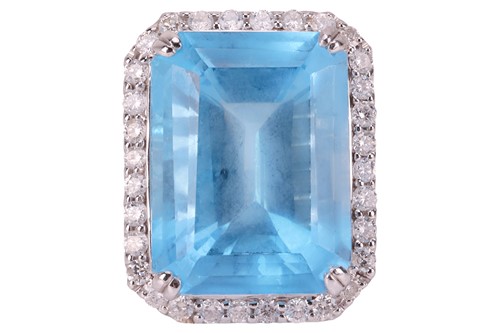 Lot 84 - A large topaz and diamond halo ring, featuring...