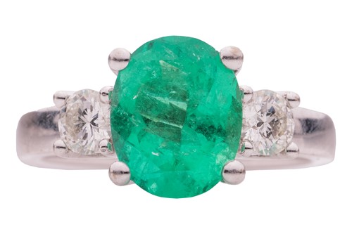 Lot 136 - An emerald and diamond three-stone ring in...