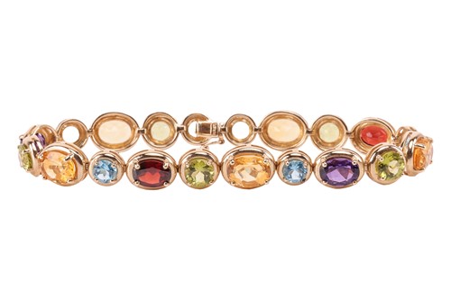 Lot 83 - A multi gem-set bracelet, claw-set with oval...
