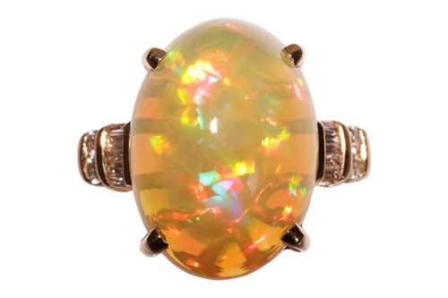 Lot 165 - An opal dress ring, featuring an oval cabochon...
