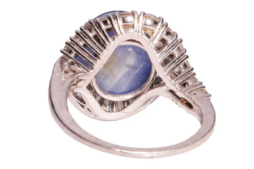 Lot 94 - A star sapphire and diamond cluster ring,...