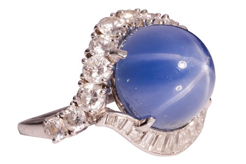 Lot 94 - A star sapphire and diamond cluster ring,...