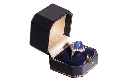 Lot 94 - A star sapphire and diamond cluster ring,...