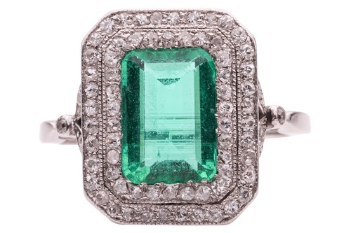 Lot 233 - An emerald and diamond-set cluster ring, the...