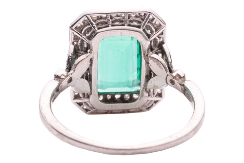 Lot 233 - An emerald and diamond-set cluster ring, the...