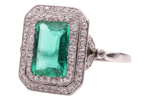 Lot 233 - An emerald and diamond-set cluster ring, the...