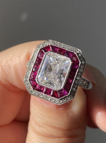Lot 232 - An Art Deco diamond and ruby cluster ring,...