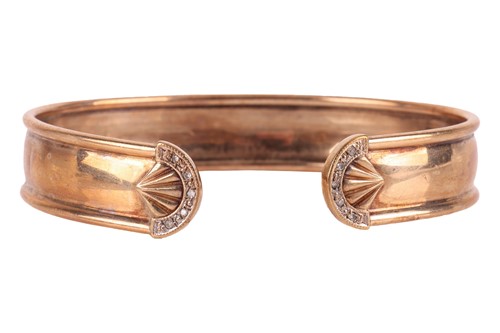 Lot 67 - An open bangle in 9ct yellow gold, of torque...