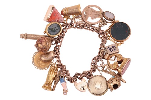 Lot 61 - A charm bracelet, comprising a yellow metal...