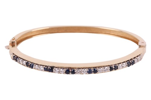 Lot 12 - A sapphire and diamond-set hinged bangle, the...