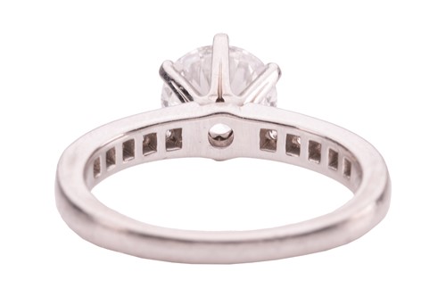 Lot 218 - Tiffany & Co. - a diamond solitaire ring in...