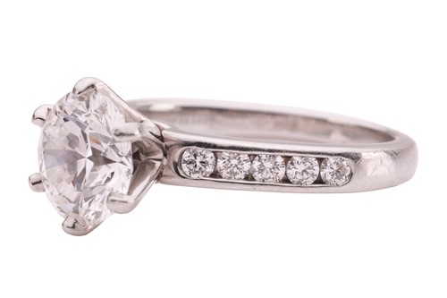 Lot 218 - Tiffany & Co. - a diamond solitaire ring in...