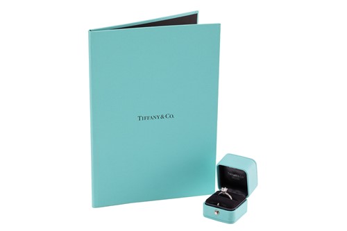 Lot 218 - Tiffany & Co. - a diamond solitaire ring in...