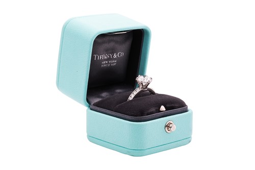 Lot 218 - Tiffany & Co. - a diamond solitaire ring in...