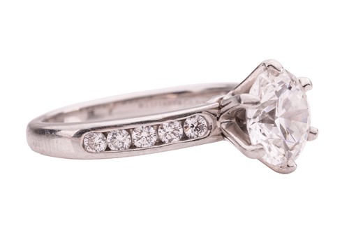 Lot 218 - Tiffany & Co. - a diamond solitaire ring in...
