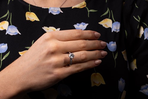 Lot 218 - Tiffany & Co. - a diamond solitaire ring in...