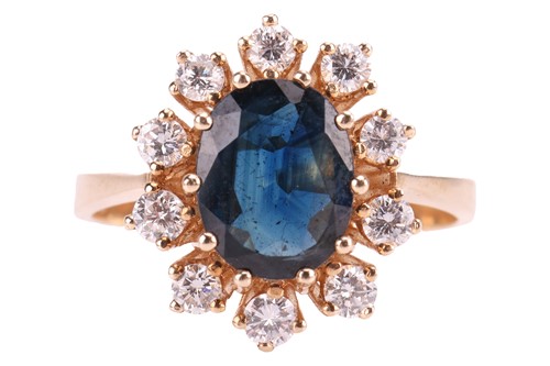 Lot 66 - A sapphire and diamond cluster ring, featuring...