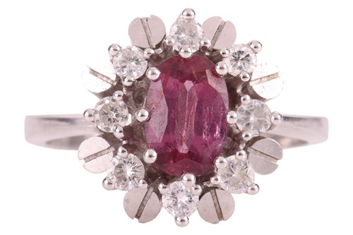 Lot 96 - A ruby and diamond cluster ring, centred with...