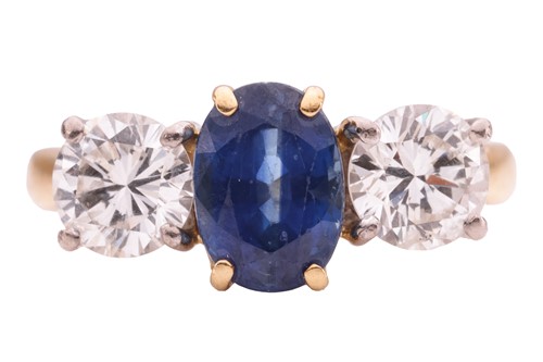 Lot 100 - A sapphire and diamond three-stone ring,...