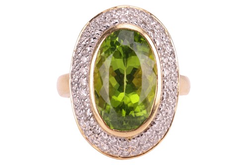 Lot 158 - A peridot and diamond cluster ring; the...