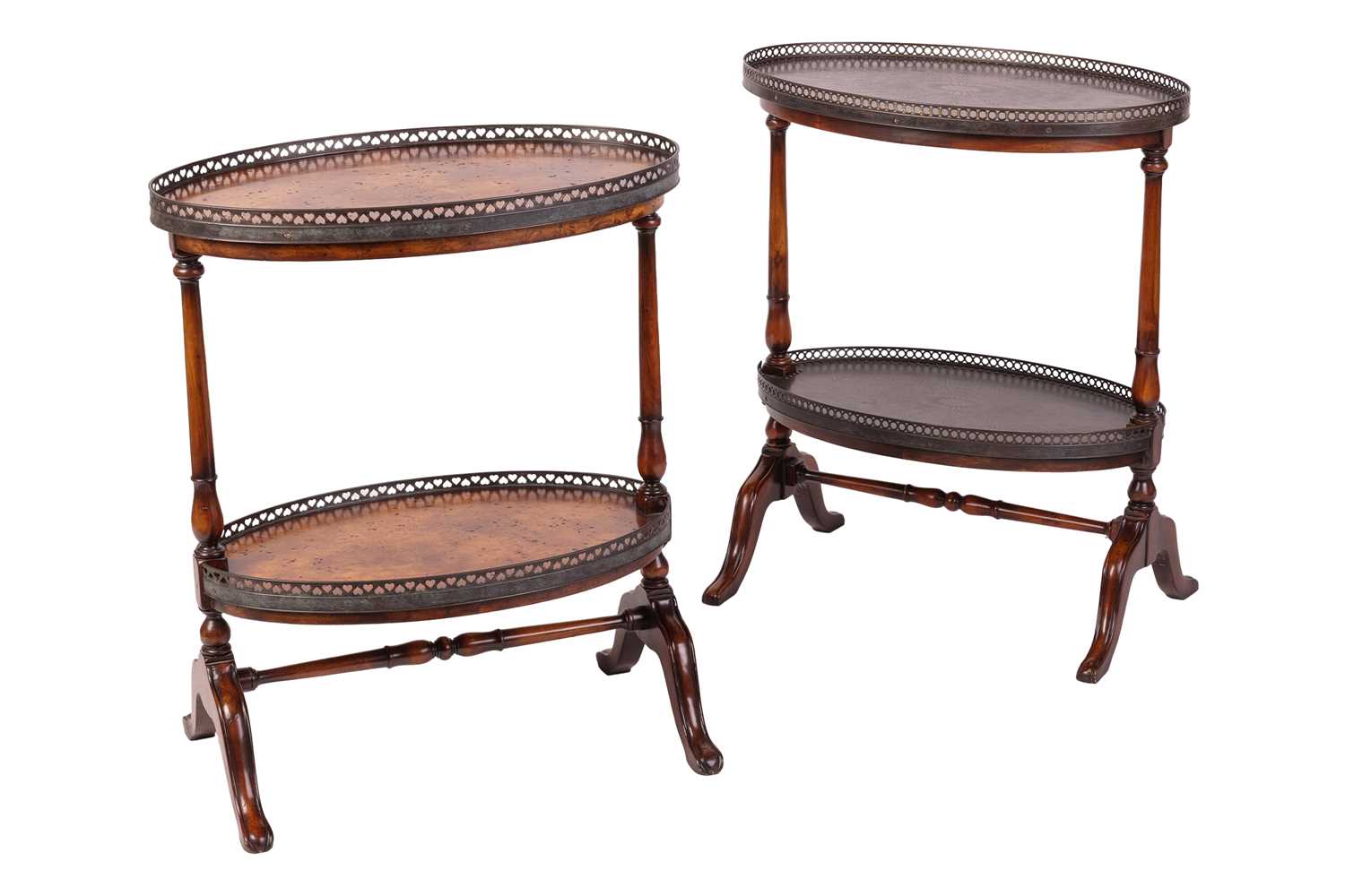 Lot 85 - A near pair of walnut oval two tier etagere...