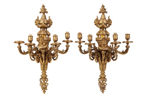 Lot 128 - A pair of Empire style gilt wall sconces, each...