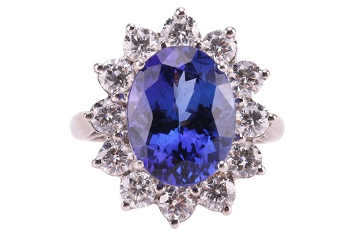 Lot 111 - A tanzanite and diamond cluster ring in 18ct...