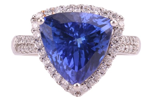 Lot 148 - A trillion-cut tanzanite and diamond halo ring,...