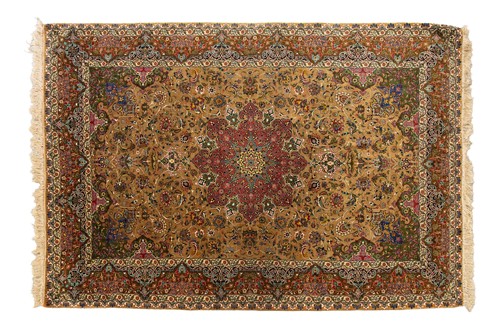 Lot 140 - An old finely woven golden ground Isfahan rug,...