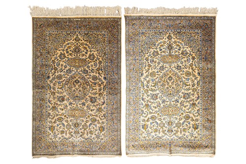 Lot 142 - A pair of old silk-on-silk Isfahan rugs, with...