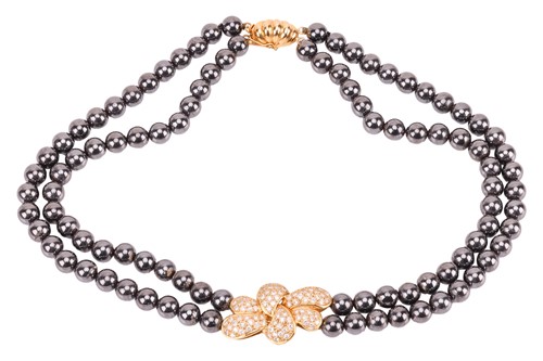 Lot 147 - A hematite bead necklace with diamond-set...